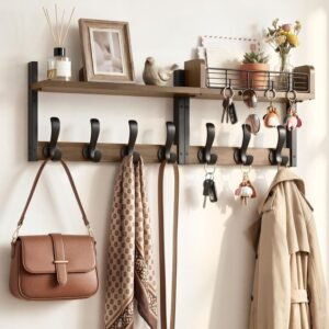 Brown multifunctional wall-mounted organizer with coat hooks and a mail slot